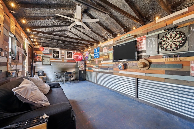 living room with concrete floors and a ceiling fan