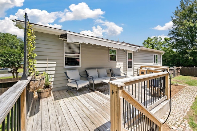 deck with an outdoor living space and fence