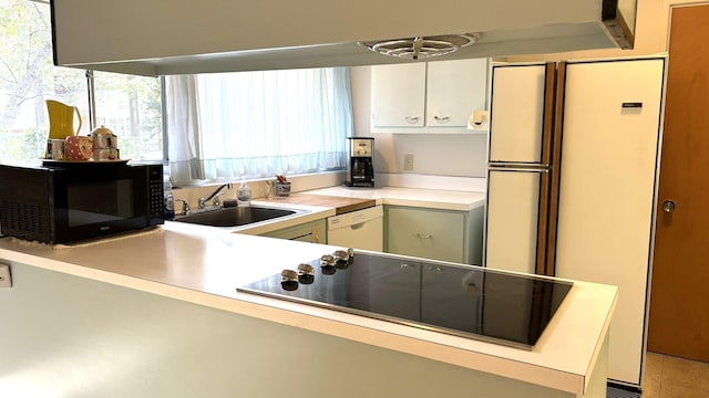 kitchen featuring white cabinetry, kitchen peninsula, sink, and black appliances