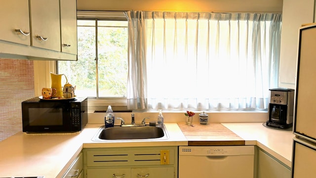 kitchen with white dishwasher and sink