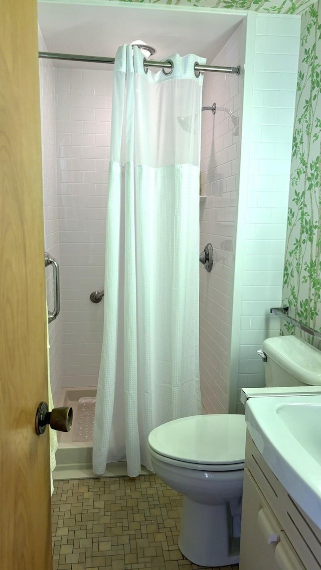 bathroom featuring walk in shower, vanity, and toilet