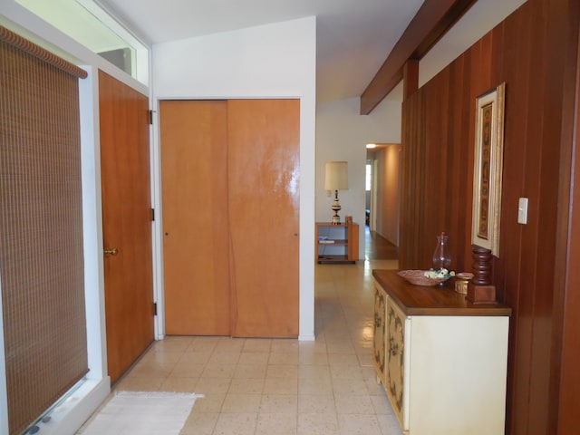 corridor with beam ceiling and wood walls