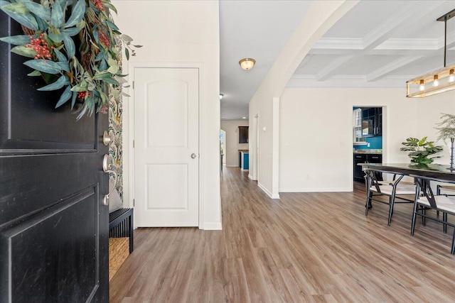 foyer with beamed ceiling, wood-type flooring, and coffered ceiling