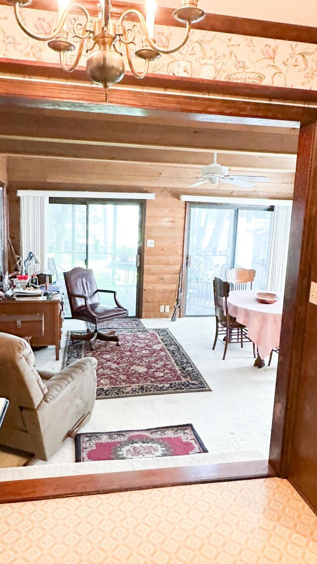 1807 Perch Rd, Moncks Corner, SC 29461 - living room featuring carpet flooring, wood walls, and a chandelier