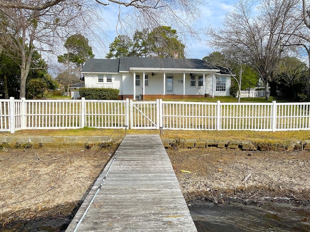 view of front of property featuring a fenced front yard, a front yard, a gate, and brick siding