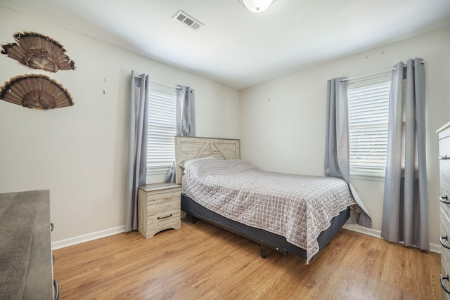 208 Mini Farm Rd, Bonneau, SC 29431 - bedroom featuring visible vents, multiple windows, and light wood-style flooring