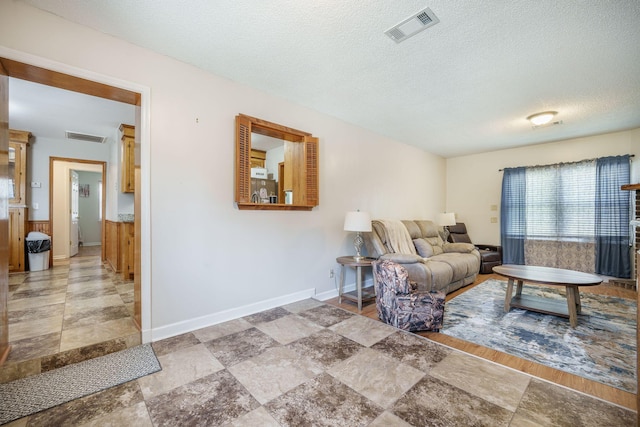 208 Mini Farm Rd, Bonneau, SC 29431 - living area featuring visible vents, baseboards, and a textured ceiling