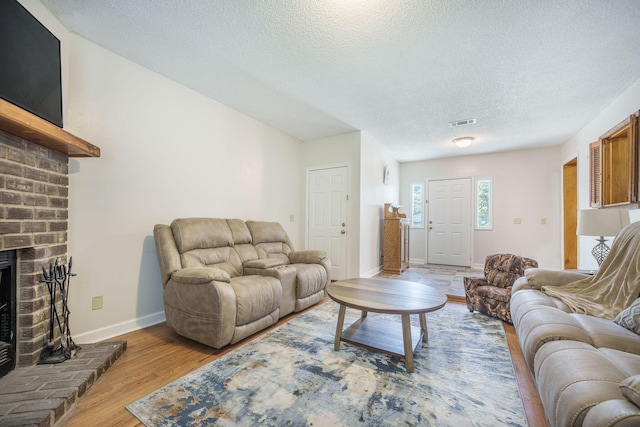 208 Mini Farm Rd, Bonneau, SC 29431 - living area with light wood-style flooring, a textured ceiling, baseboards, and visible vents