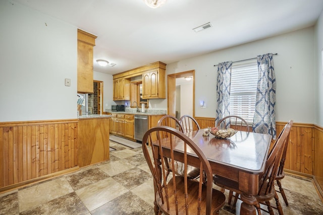 208 Mini Farm Rd, Bonneau, SC 29431 - dining space featuring wood walls, stone finish floor, wainscoting, and visible vents
