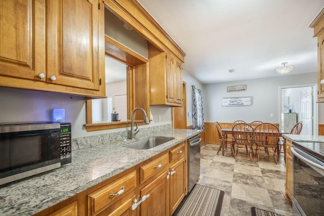 208 Mini Farm Rd, Bonneau, SC 29431 - kitchen featuring a wainscoted wall, light stone countertops, brown cabinets, stainless steel appliances, and a sink