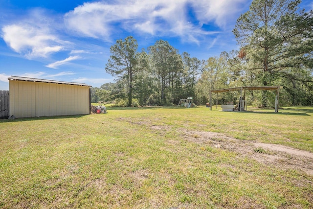 208 Mini Farm Rd, Bonneau, SC 29431 - view of yard with a carport, a pole building, an outdoor structure, and a playground