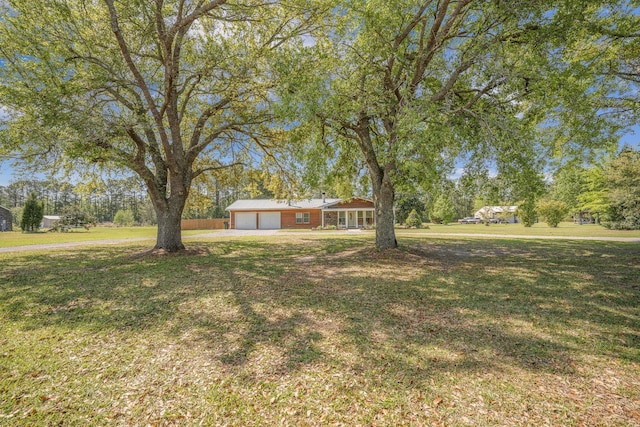 208 Mini Farm Rd, Bonneau, SC 29431 - view of yard with an attached garage and driveway