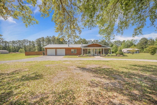 208 Mini Farm Rd, Bonneau, SC 29431 - ranch-style home with a front yard, driveway, metal roof, and a garage