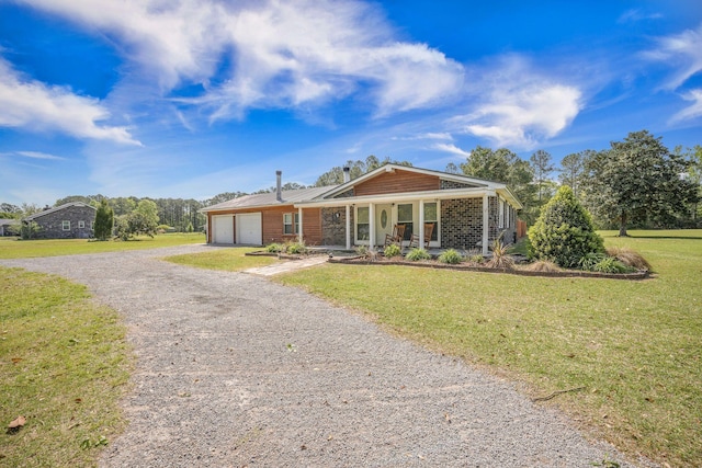 208 Mini Farm Rd, Bonneau, SC 29431 - view of front of property with driveway, a front yard, a porch, a garage, and metal roof