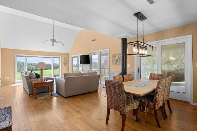 2473 High Hammock Rd, Seabrook Island, SC 29455 - dining room with light wood-style flooring, a ceiling fan, high vaulted ceiling, and a wood stove