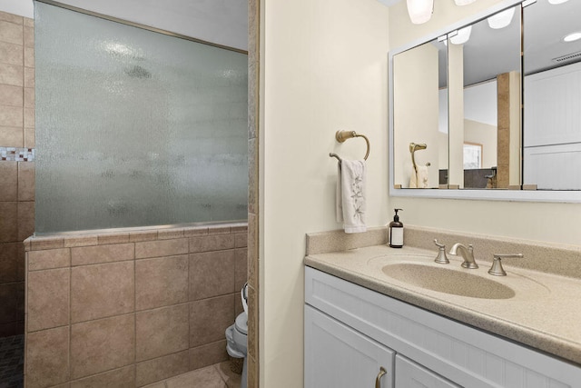 bathroom featuring tile patterned flooring, vanity, and toilet