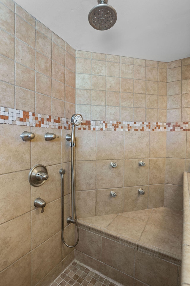 bathroom with a tile shower