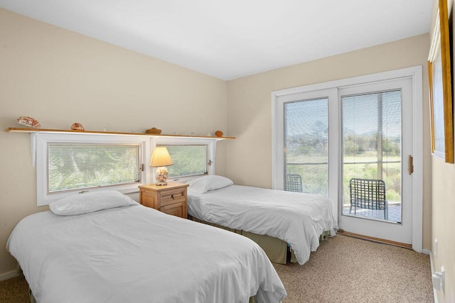 2473 High Hammock Rd, Seabrook Island, SC 29455 - bedroom with multiple windows, access to exterior, light colored carpet, and baseboards