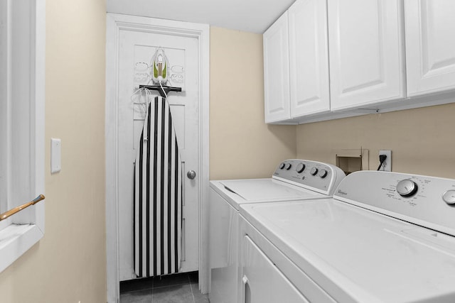 laundry area featuring cabinets, tile patterned flooring, and independent washer and dryer