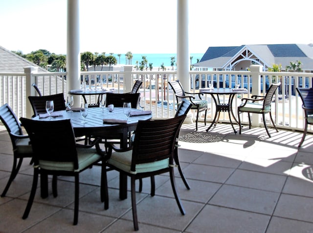 view of patio with a water view and a balcony