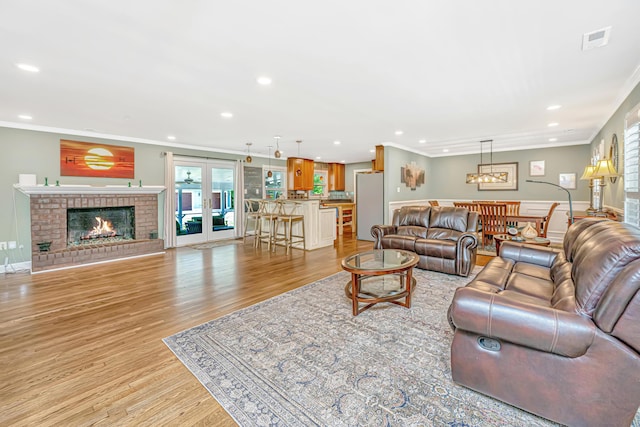 762 Swanson Ave, Charleston, SC 29412 - living room with crown molding, recessed lighting, plenty of natural light, light wood-type flooring, and a fireplace