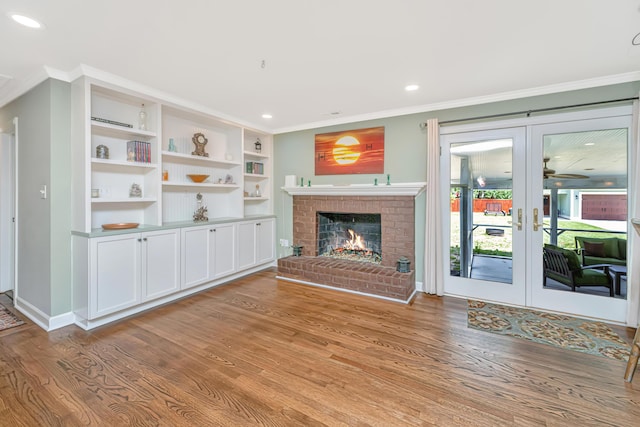 762 Swanson Ave, Charleston, SC 29412 - unfurnished living room with ornamental molding, light wood finished floors, a brick fireplace, french doors, and recessed lighting