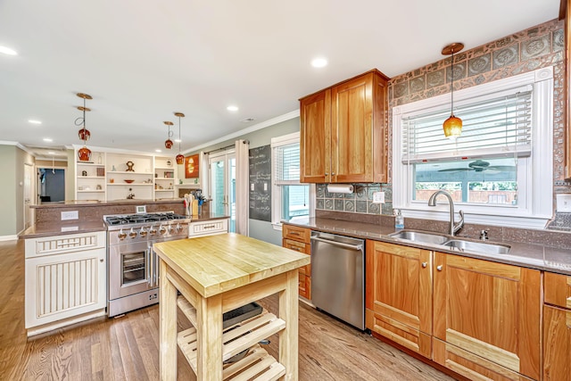 762 Swanson Ave, Charleston, SC 29412 - kitchen featuring appliances with stainless steel finishes, crown molding, light wood-style flooring, hanging light fixtures, and wooden counters