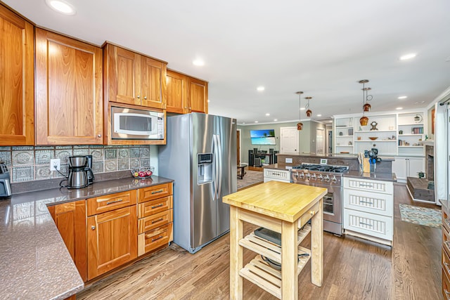 762 Swanson Ave, Charleston, SC 29412 - kitchen with stainless steel appliances, brown cabinetry, recessed lighting, decorative backsplash, and light wood-style floors