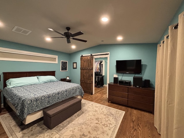 762 Swanson Ave, Charleston, SC 29412 - bedroom with wood finished floors, vaulted ceiling, a spacious closet, a ceiling fan, and a barn door