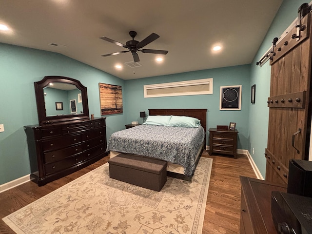 762 Swanson Ave, Charleston, SC 29412 - bedroom with a barn door, lofted ceiling, dark wood-style flooring, ceiling fan, and recessed lighting