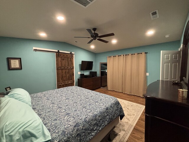 762 Swanson Ave, Charleston, SC 29412 - bedroom featuring a barn door, vaulted ceiling, wood finished floors, recessed lighting, and ceiling fan