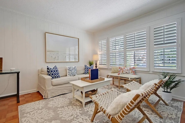 sitting room with a textured ceiling, wood walls, and hardwood / wood-style floors