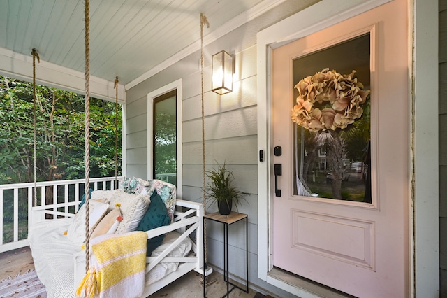 view of exterior entry featuring a porch