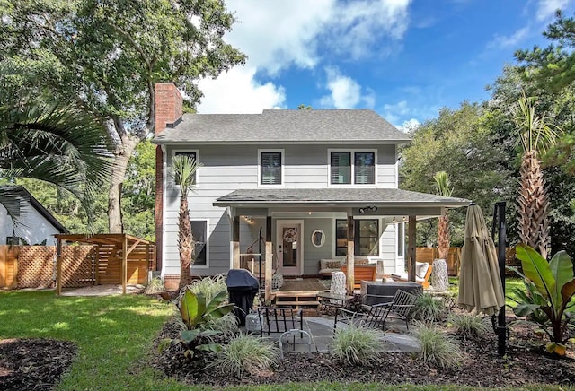 back of house featuring a yard