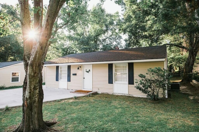 single story home with a front yard and a patio