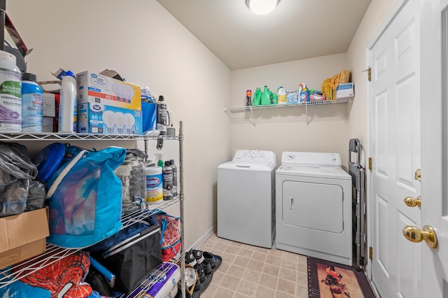 clothes washing area with washing machine and dryer