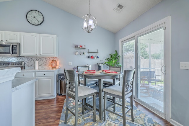 210 Delafield Dr, Summerville, SC 29483 - dining area featuring vaulted ceiling, dark wood-style flooring, and a chandelier