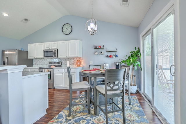 210 Delafield Dr, Summerville, SC 29483 - kitchen with appliances with stainless steel finishes, vaulted ceiling, white cabinetry, backsplash, and light countertops