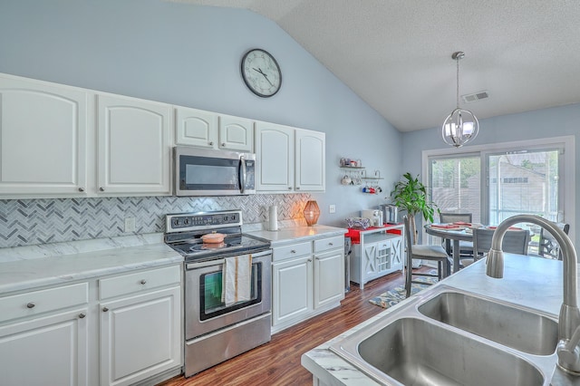 210 Delafield Dr, Summerville, SC 29483 - kitchen with appliances with stainless steel finishes, a sink, vaulted ceiling, backsplash, and dark wood-style floors