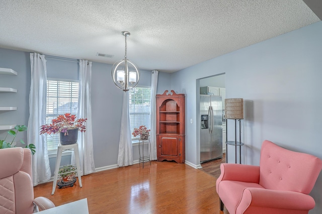 210 Delafield Dr, Summerville, SC 29483 - sitting room with a chandelier, wood finished floors, a textured ceiling, and baseboards