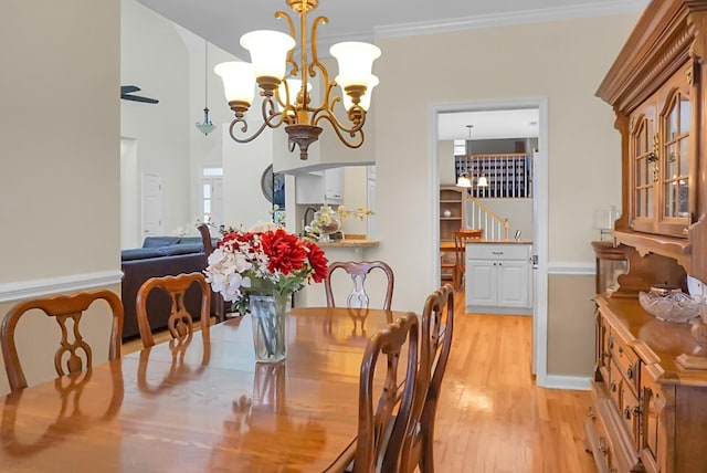 652 Spinner Cir, Mount Pleasant, SC 29464 - dining space featuring a chandelier, light wood-style floors, stairs, and crown molding