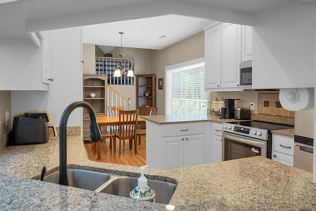 652 Spinner Cir, Mount Pleasant, SC 29464 - kitchen with stainless steel appliances, a chandelier, and white cabinetry