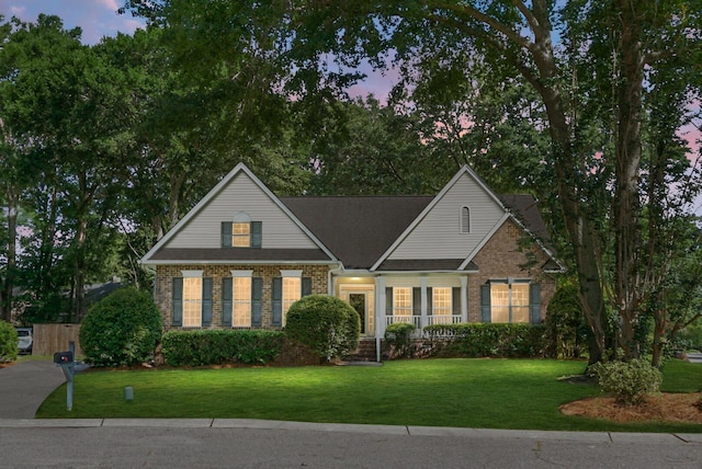 652 Spinner Cir, Mount Pleasant, SC 29464 - view of front facade featuring a front yard, a porch, and brick siding