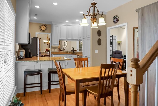652 Spinner Cir, Mount Pleasant, SC 29464 - dining space with a chandelier, light wood-style flooring, and recessed lighting