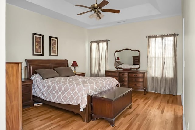 652 Spinner Cir, Mount Pleasant, SC 29464 - bedroom featuring light wood-style floors and a tray ceiling