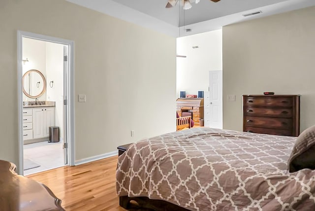 652 Spinner Cir, Mount Pleasant, SC 29464 - bedroom featuring light wood-type flooring, ensuite bath, and ceiling fan