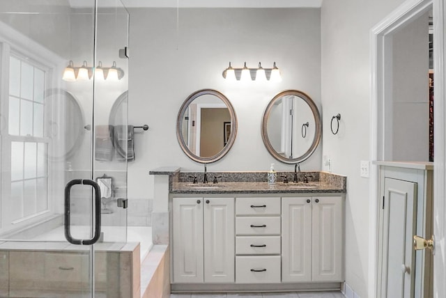 652 Spinner Cir, Mount Pleasant, SC 29464 - bathroom with double vanity, a stall shower, and a garden tub