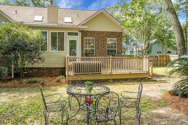 652 Spinner Cir, Mount Pleasant, SC 29464 - back of house featuring a wooden deck, a chimney, brick siding, and a shingled roof