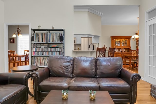 652 Spinner Cir, Mount Pleasant, SC 29464 - living area with a chandelier, light wood-style flooring, and crown molding