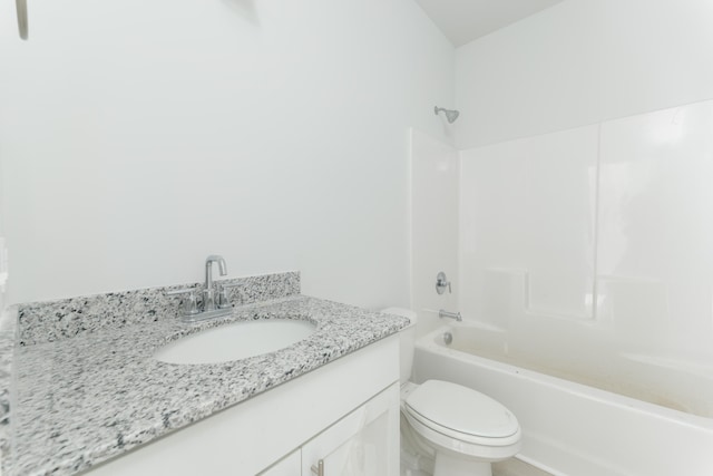 full bathroom featuring vanity, bathtub / shower combination, and toilet